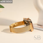 Rose gold Apple Watch with a matching mesh band. The watch face and band are a warm, metallic color. The band has a woven texture and a secure clasp. The words "ROSE GOLD" are in a white box in the upper left corner.