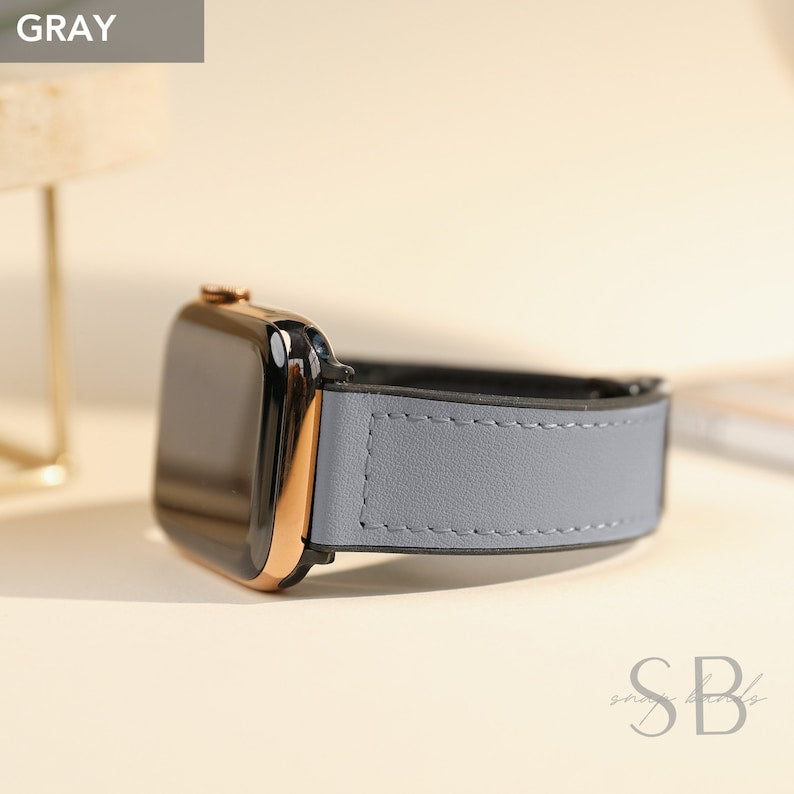 A gray leather watch band attached to a black smartwatch with a gold-colored bezel. The word "GRAY" is in a gray box in the upper left corner. The watch band is stitched with white thread.