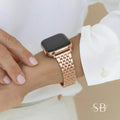 Rose gold watch with a rectangular face and a matching link band. The watch is worn on a wrist, with a white shirt sleeve visible in the background. The watch band is approximately 7 inches (17.78 cm) long.