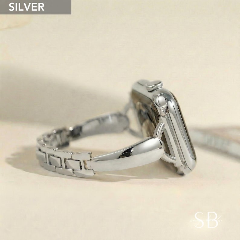 A silver watch with a matching link band. The watch face is rectangular with rounded corners. The band is made of small, rectangular links. The word "SILVER" is in a gray box in the upper left corner.